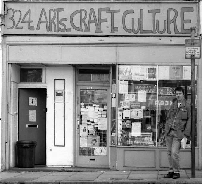 Jah Shaka's Arts, Craft and Culture shop in New Cross, South East London, 1980s, with a young Russ Disciple standing outside